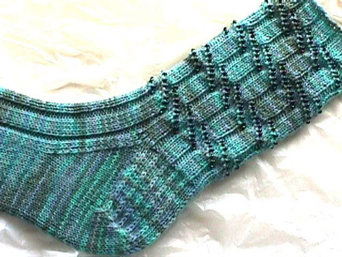 Bead Ribbed Socks are designed for those multi-colored sock yarns you can't resist. Beads highlight the easy interrupted rib pattern stitch.