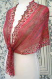Shallow Tri Shawl worn in traditional triangle shawl style with front tails tied